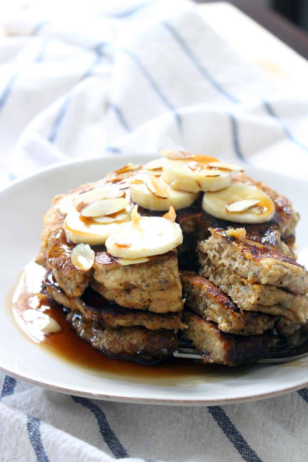 Banana Chia Seed Pancakes | Hearty, delicious, and fluffy banana pancakes with chia seeds added, made with whole wheat flour and sweetened with honey. A healthy, energy boosting breakfast!