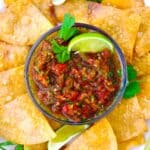 Homemade red Texas Salsa in a small bowl with a lime wedge and cilantro.