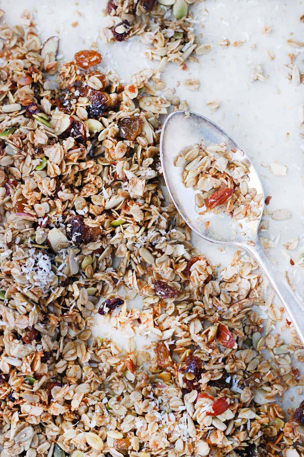 Bird's eye view of granola with a silver antique spoon on the side.