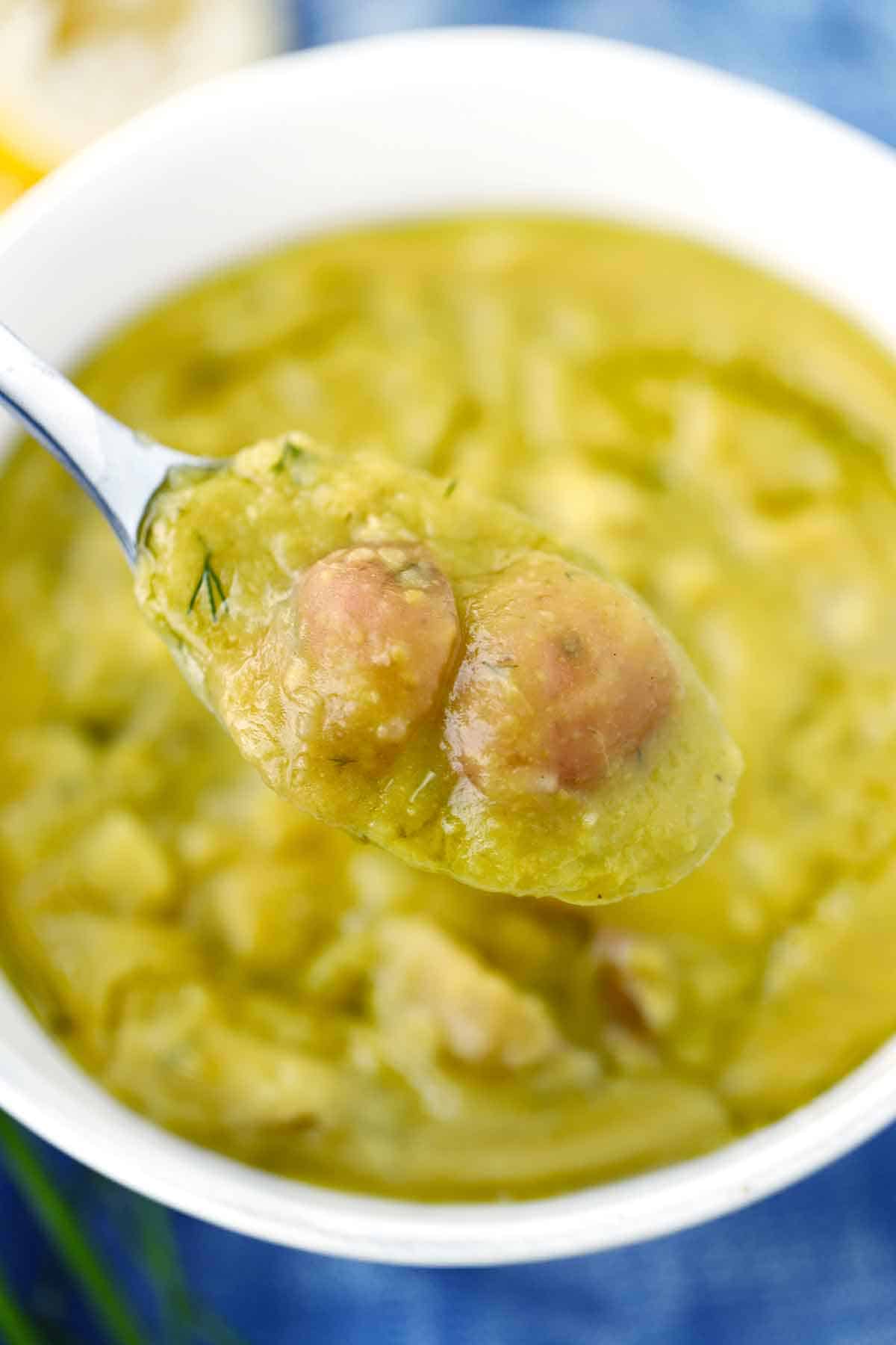 A spoonful of split pea soup with potatoes.