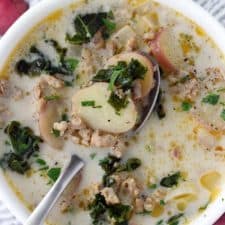 The Olive Garden's famous Zuppa Toscana is so easy to make from scratch at home with only a few ingredients! A creamy, gluten-free soup with Italian sausage, potatoes, and kale.
