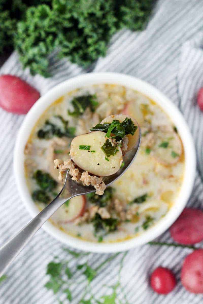 The Olive Garden's famous Zuppa Toscana is so easy to make from scratch at home with only a few ingredients! A creamy, gluten-free soup with Italian sausage, potatoes, and kale.