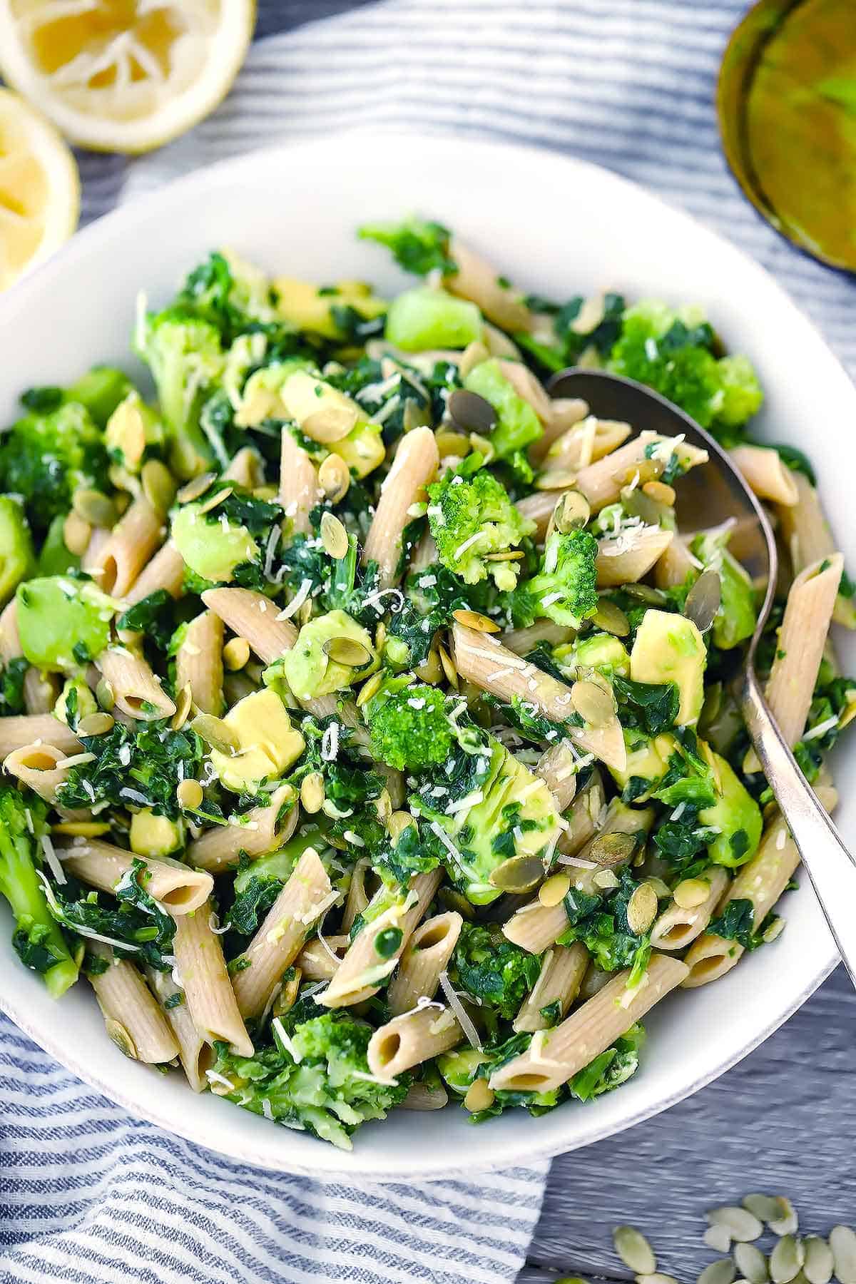 Overhead photo of pasta salad with parmesan, broccoli, and avocado.