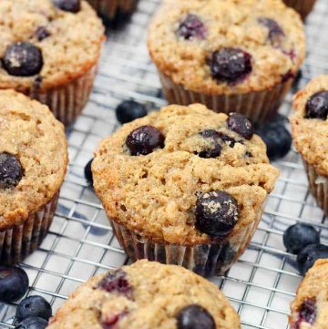 Close up of blueberry banana oat muffins on a cooling rack.