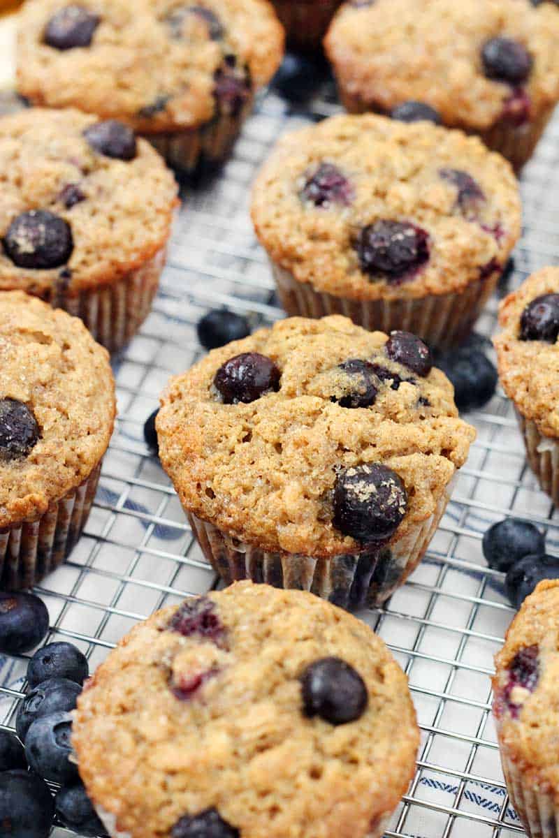 Close up of blueberry banana oat muffins on a cooling rack.