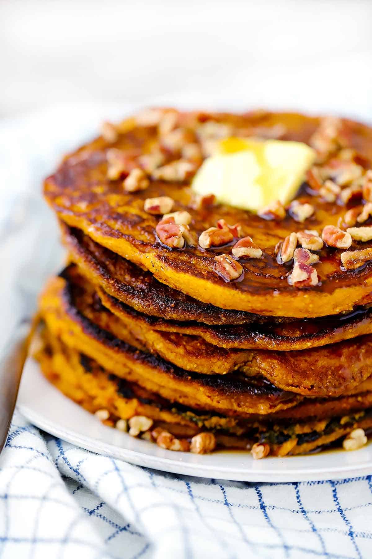 Close up photo of a stack of pumpkin pancakes.