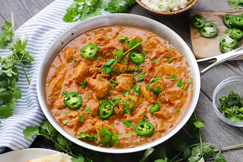 Horizontal photo of chicken tikka masala in a skillet.