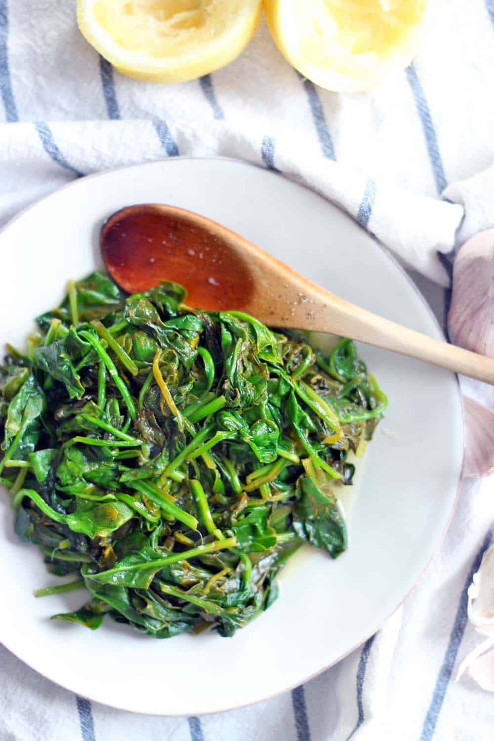 5-Minute Sauteed Spinach with Garlic and Lemon | The BEST and FASTEST way to use up almost wilted spinach... or any other greens! Bright and savory with lemon and garlic flavors- the perfect side to almost any meal.