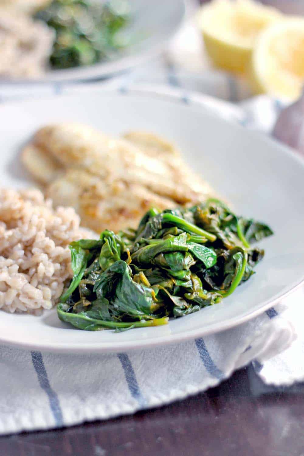 5-Minute Sauteed Spinach with Garlic and Lemon | The BEST and FASTEST way to use up almost wilted spinach... or any other greens! Bright and savory with lemon and garlic flavors- the perfect side to almost any meal.