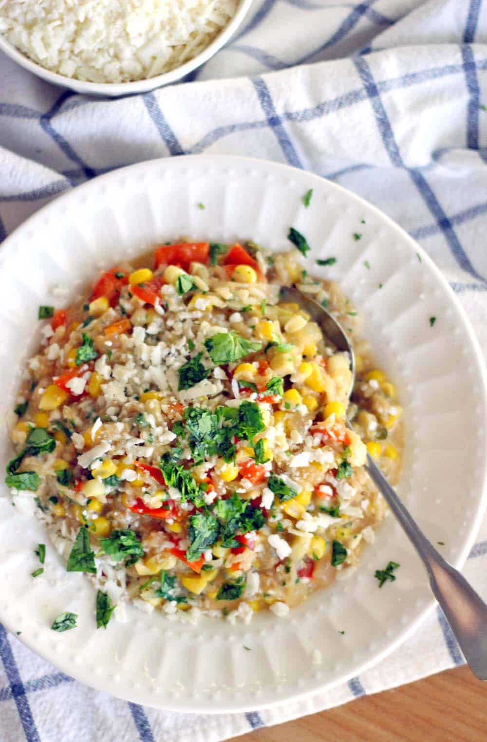 This easy brown rice risotto has a Mexican twist with red bell and jalapeno peppers, sweet fresh corn, and cotija cheese melted into every bite. Delicious as a side or as a main course!