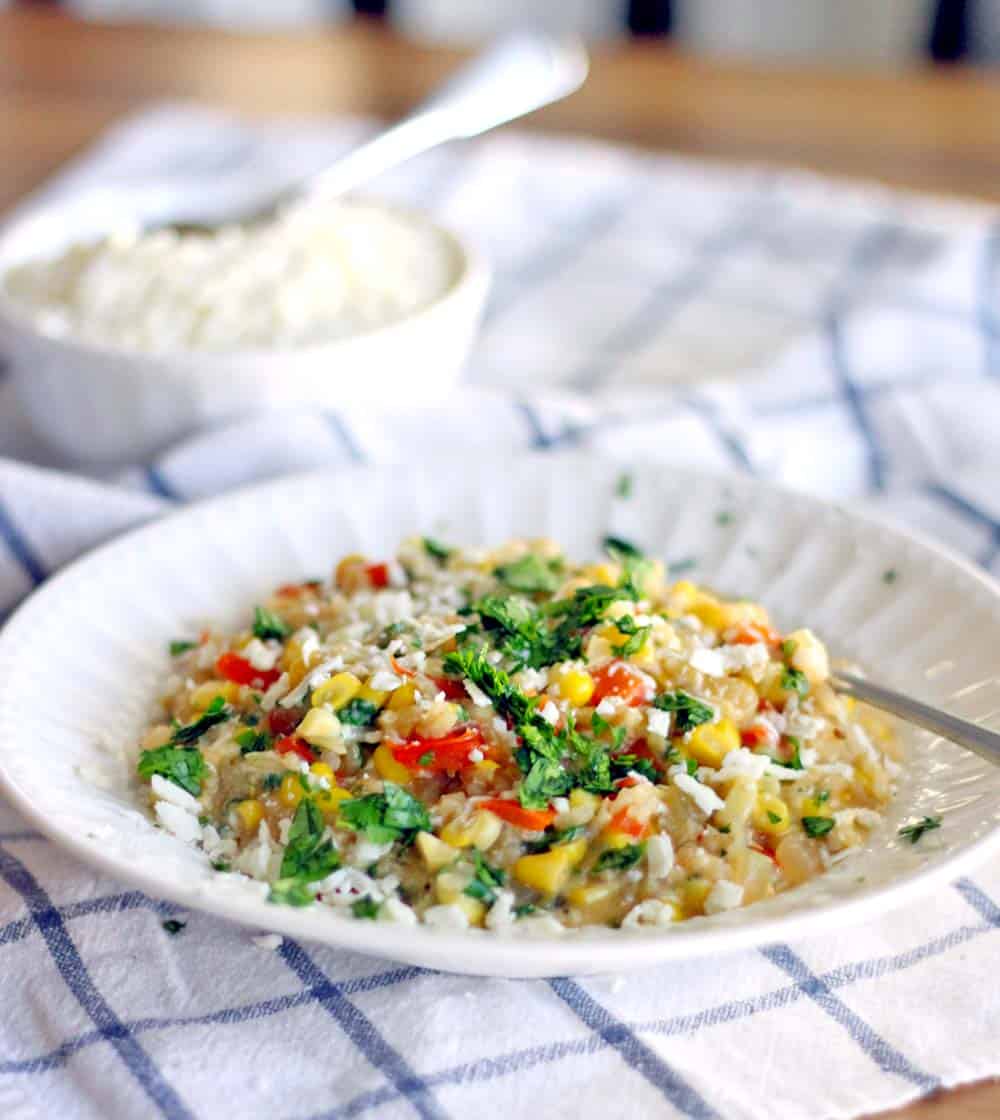 This easy brown rice risotto has a Mexican twist with red bell and jalapeno peppers, sweet fresh corn, and cotija cheese melted into every bite. Delicious as a side or as a main course!