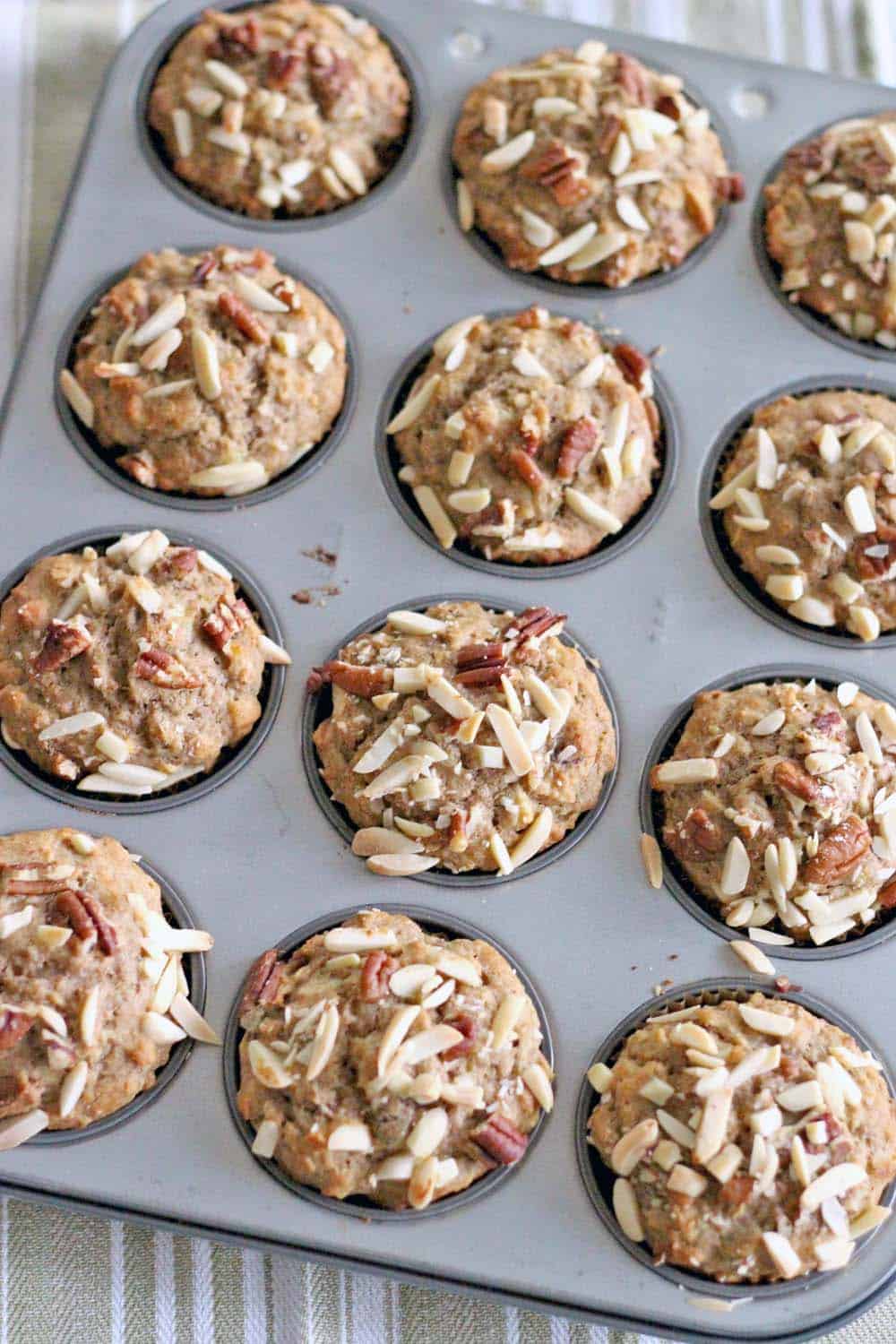 Whole Wheat Banana Oat and Toasted Nut Muffins | These muffins are 100% whole grain and guilt-free, packed full of nuts for protein and banana for natural sweetness. They are moist, delicious, and can be made in bulk and frozen for easy busy morning breakfasts!
