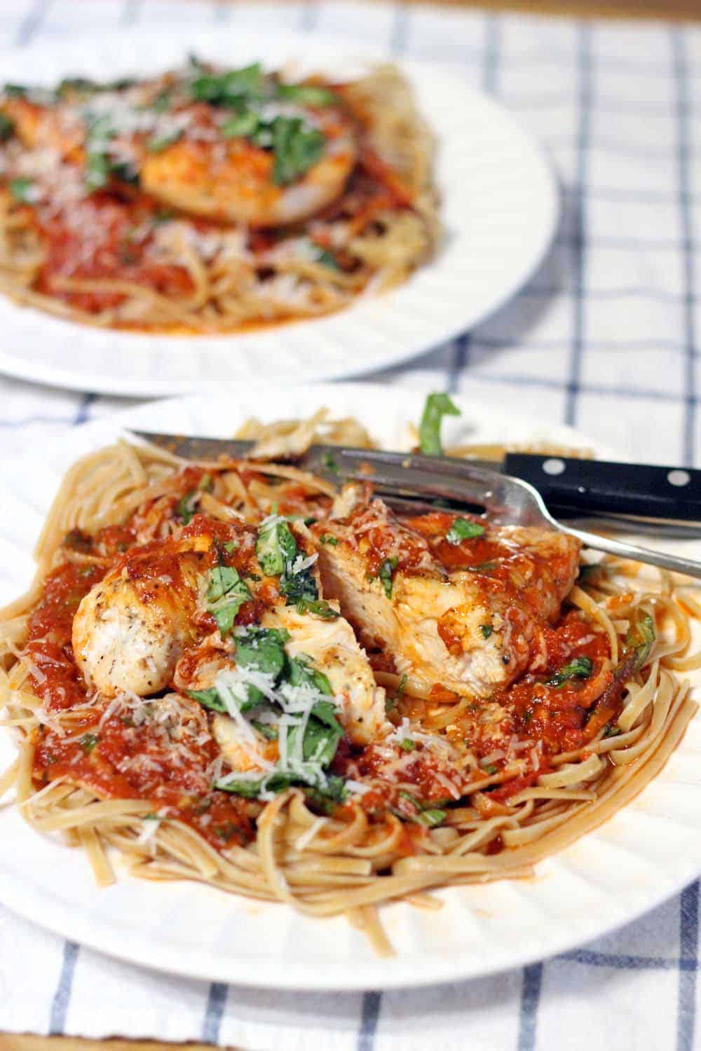 Chicken and Linguine with Tomato Basil Butter Sauce | Perfectly seared chicken with easy, buttery marinara sauce served atop a bed of whole wheat linguine- tastes like Italy, but is so quick and easy to make on a weeknight!