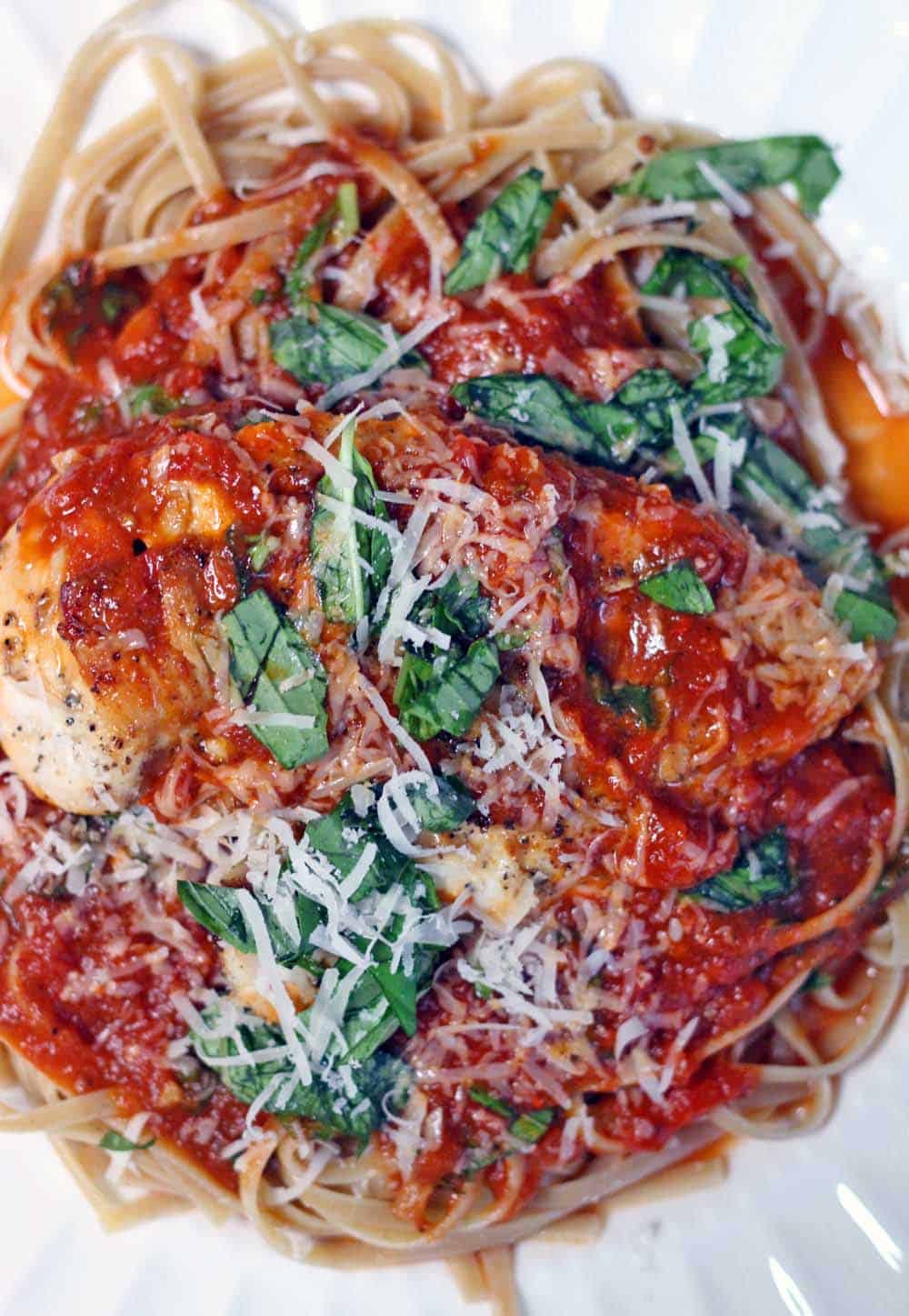 Chicken and Linguine with Tomato Basil Butter Sauce | Perfectly seared chicken with easy, buttery marinara sauce served atop a bed of whole wheat linguine- tastes like Italy, but is so quick and easy to make on a weeknight!