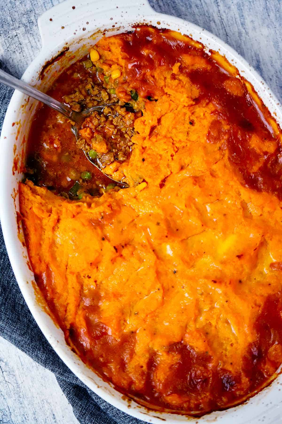 Overhead photo of an oval casserole dish with sweet potato and turkey shepherd's pie.