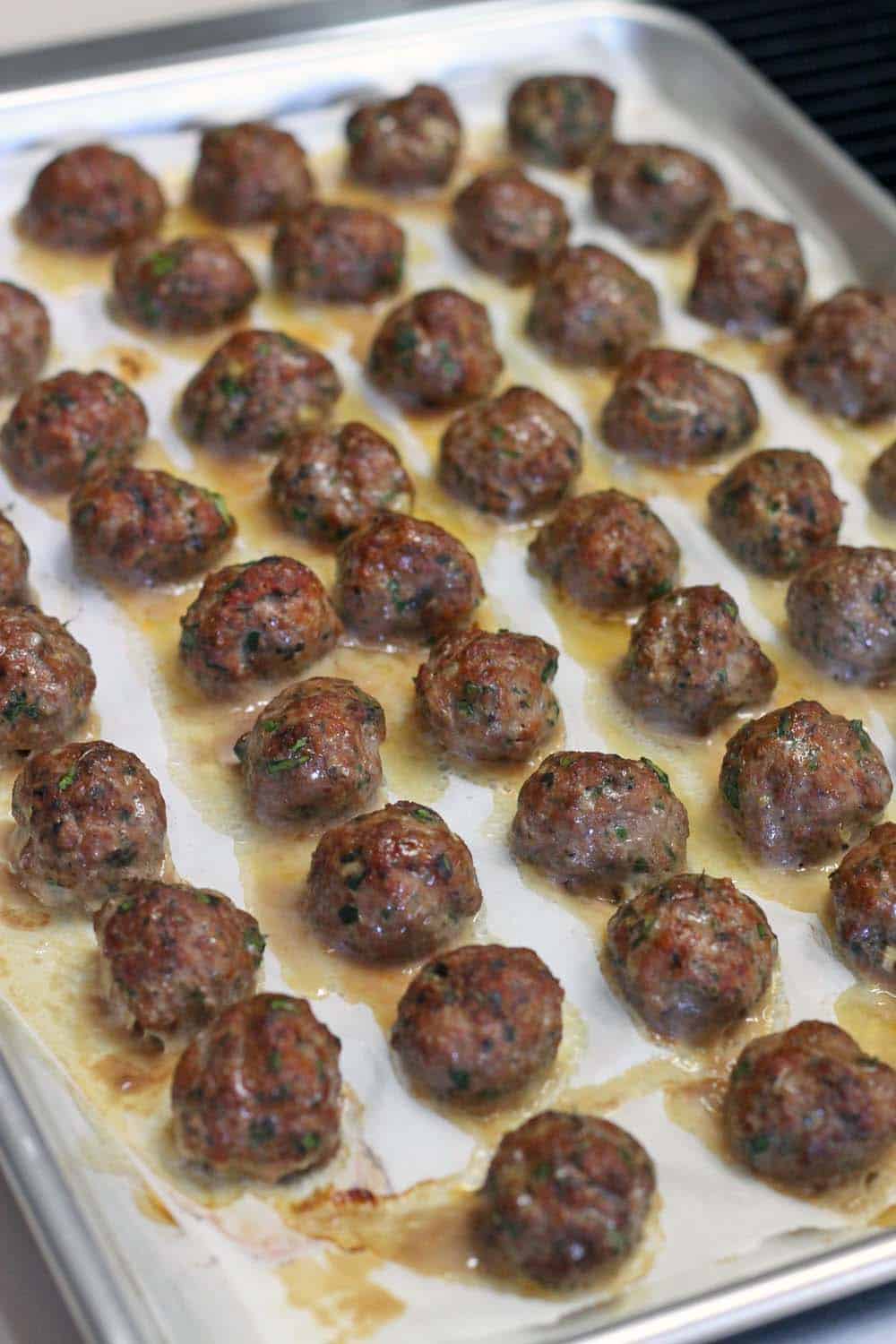 This Paleo/Whole30 baked version of Greek Meatballs (Keftedes) are paired with a super easy Romesco Sauce. The PERFECT make-ahead appetizer for your next party!