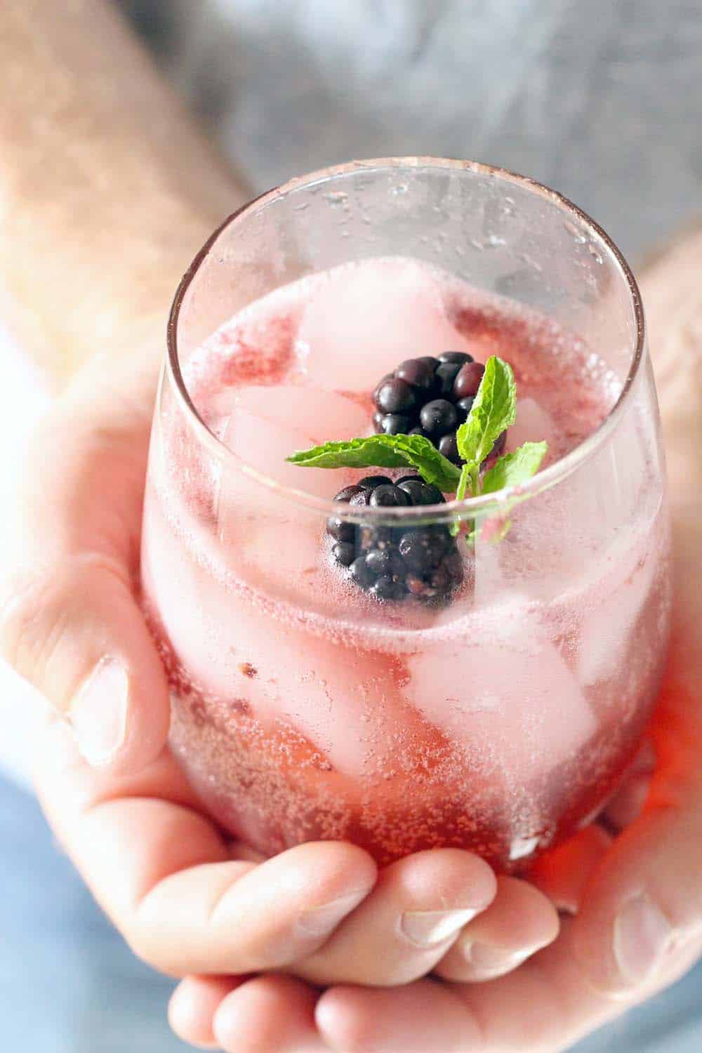 This non-alcoholic cocktail (mocktail!) is delicious, healthy, and paleo! Fresh blackberries, mint, lemon juice, honey, and seltzer make a delicious and refreshing party beverage.