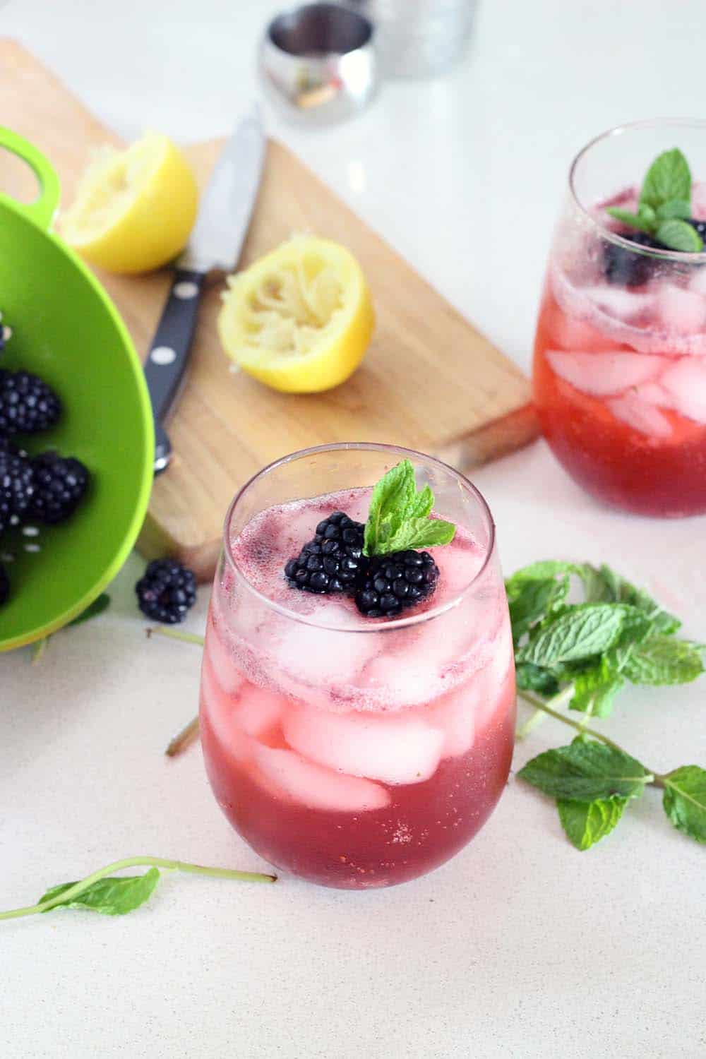 This non-alcoholic cocktail (mocktail!) is delicious, healthy, and paleo! Fresh blackberries, mint, lemon juice, honey, and seltzer make a delicious and refreshing party beverage.