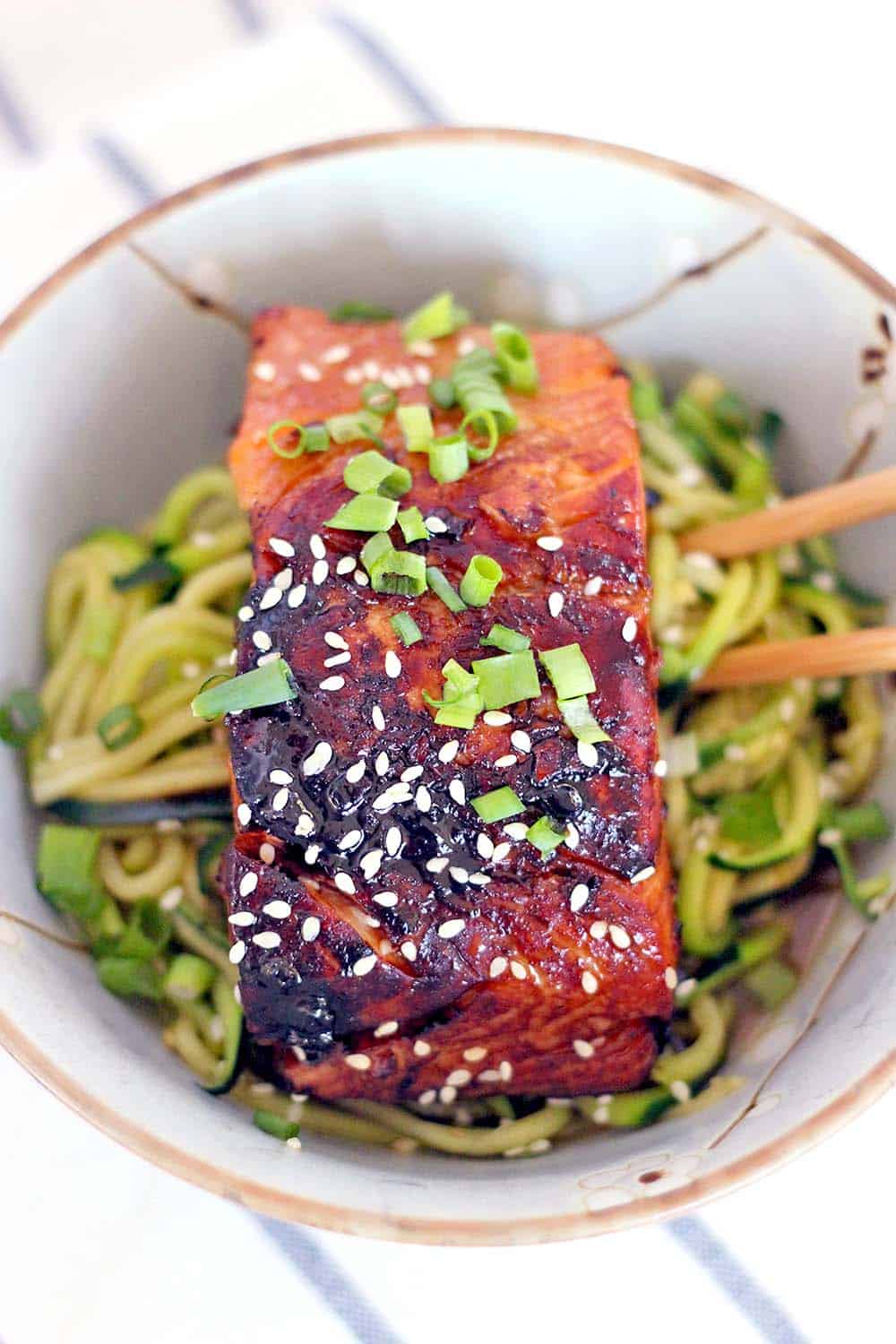 This healthy, low carb Teriyaki Salmon and Zucchini Noodle Bowl takes a mere FIFTEEN MINUTES to make and is bursting with that awesome Asian flavor you crave.