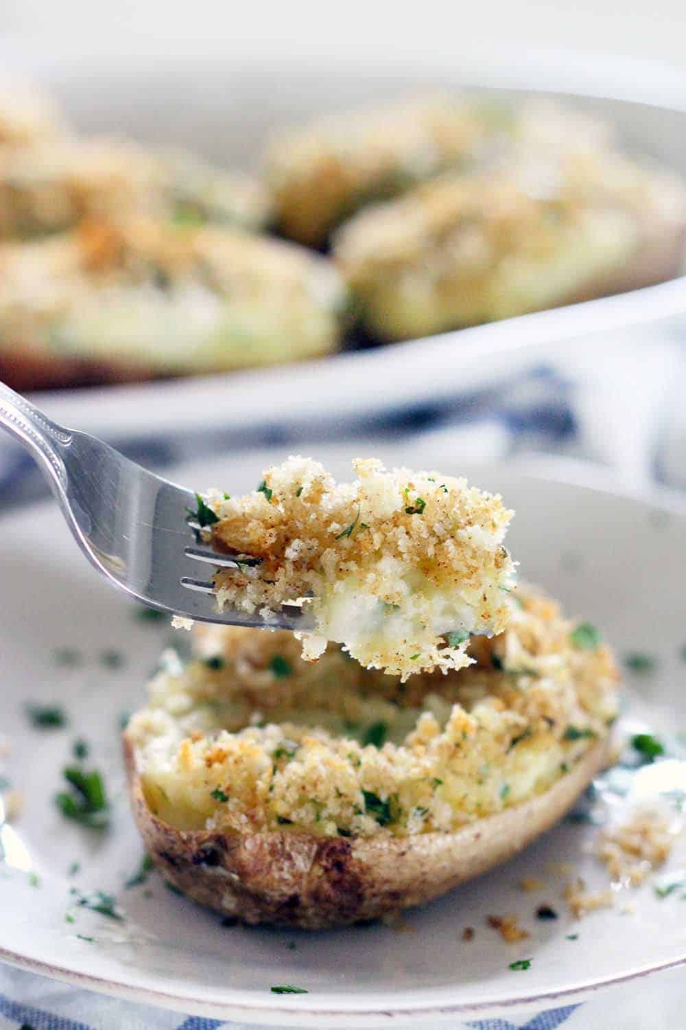 Creamy on the inside, crunchy breadcrumb topping on the outside- these are the BEST twice baked potatoes EVER! Plus, they're freezable if you assemble ahead of time or have leftovers. They're my late grandfather's famous family recipe.