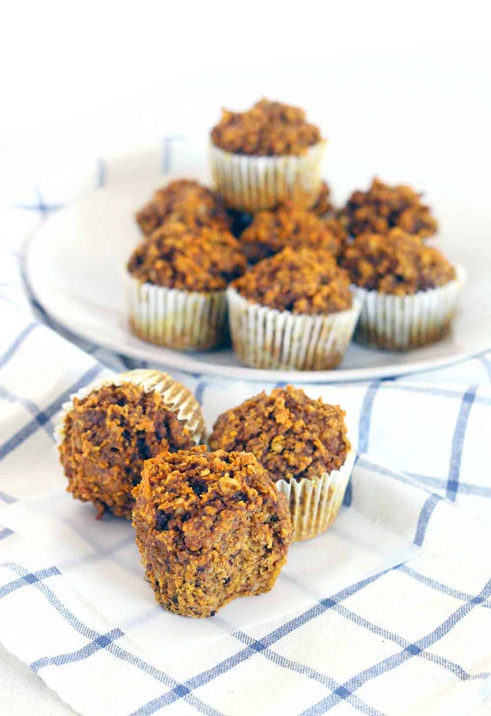 These Gluten Free Pumpkin Oat Muffins are packed with healthy ingredients like oats, pumpkin, and walnuts. They're more like a delicious energy bar than a muffin, and are the perfect hearty grab and go breakfast.