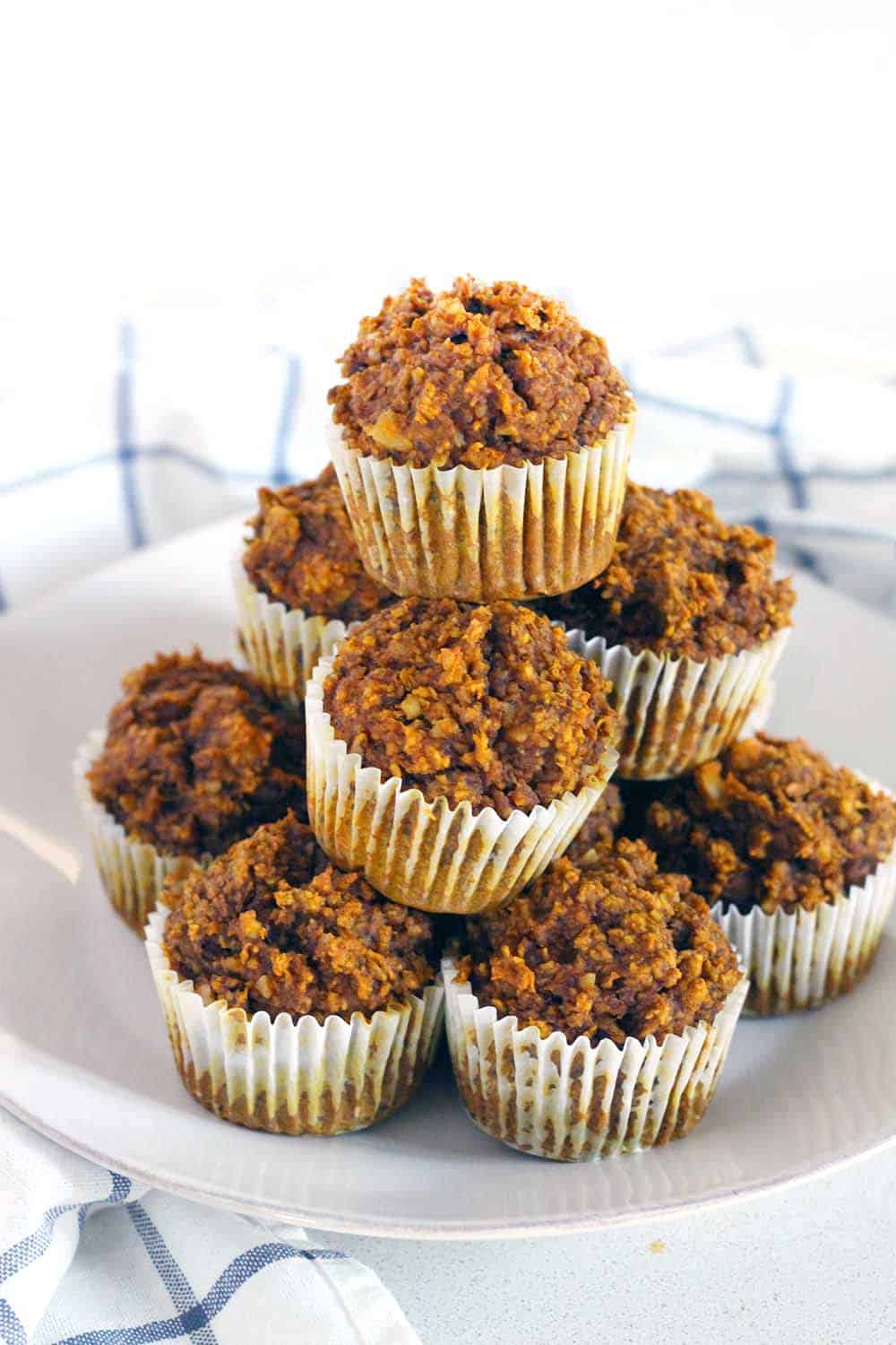 These Gluten Free Pumpkin Oat Muffins are packed with healthy ingredients like oats, pumpkin, and walnuts. They're more like a delicious energy bar than a muffin, and are the perfect hearty grab and go breakfast.