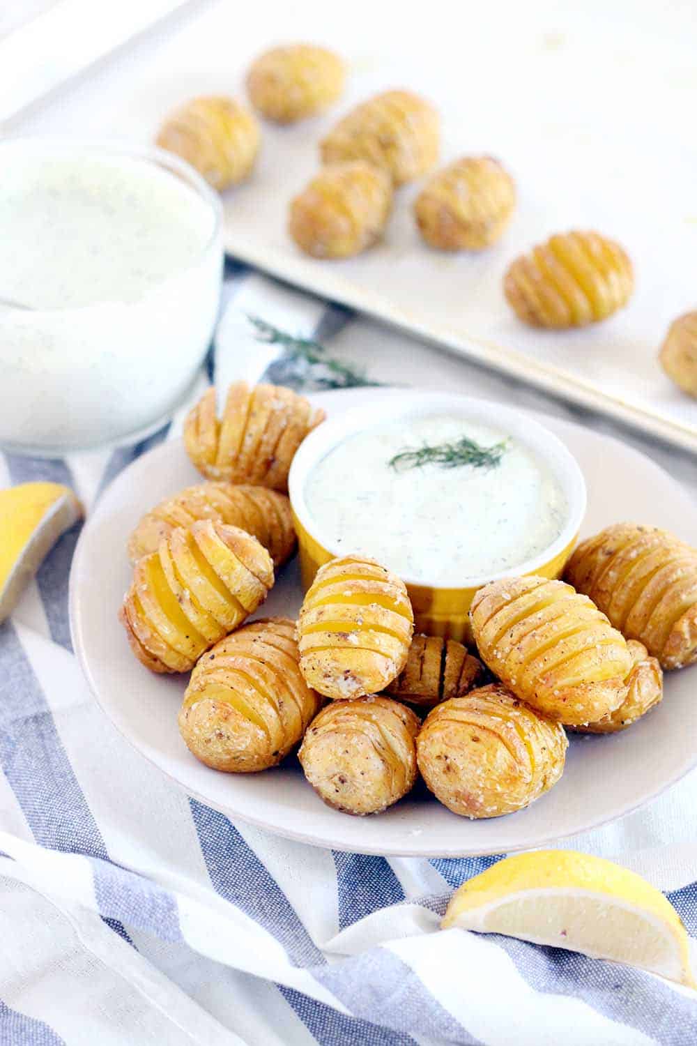 Perfect as an appetizer, these Mini Hasselback Potatoes with Creamy Dill Dip are dunkable and delicious! Gluten free, vegetarian, and perfect for the holidays.