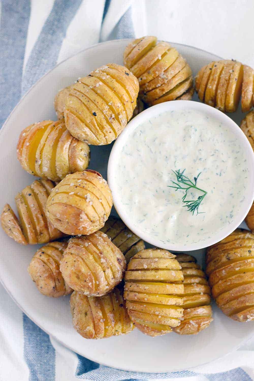 Perfect as an appetizer, these Mini Hasselback Potatoes with Creamy Dill Dip are dunkable and delicious! Gluten free, vegetarian, and perfect for the holidays.