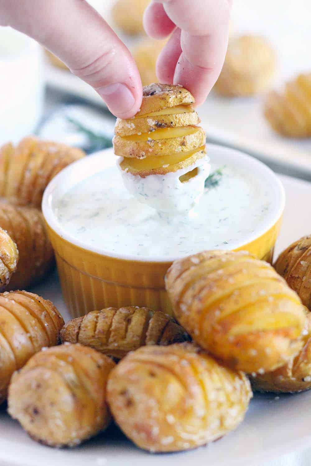 Perfect as an appetizer, these Mini Hasselback Potatoes with Creamy Dill Dip are dunkable and delicious! Gluten free, vegetarian, and perfect for the holidays.