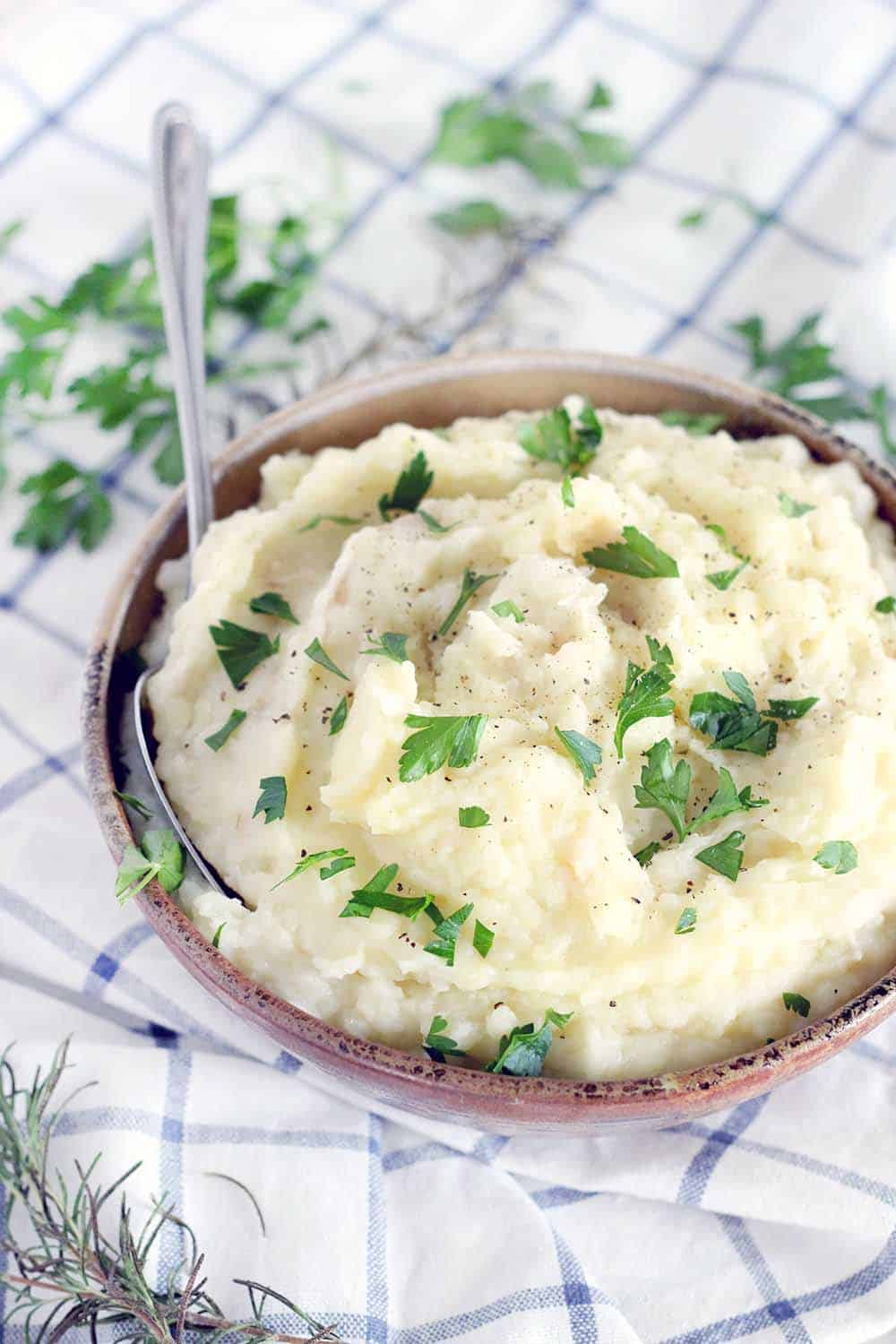 This Rosemary Infused Potato and Cauliflower Mash is a rich, earthy, wonderfully delicious, lower carb alternative to traditional mashed potatoes! Perfect for your Thanksgiving or holiday table.