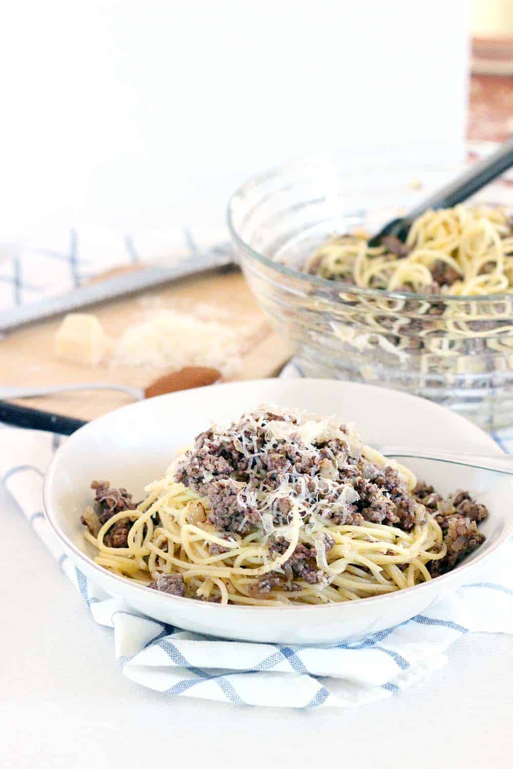 This recipe for Greek Spaghetti has browned beef spiced with cinnamon, is drizzled with earthy browned butter, and is sprinkled with Romano cheese. It's the ULTIMATE Greek comfort food! | www.bowlofdelicious.com