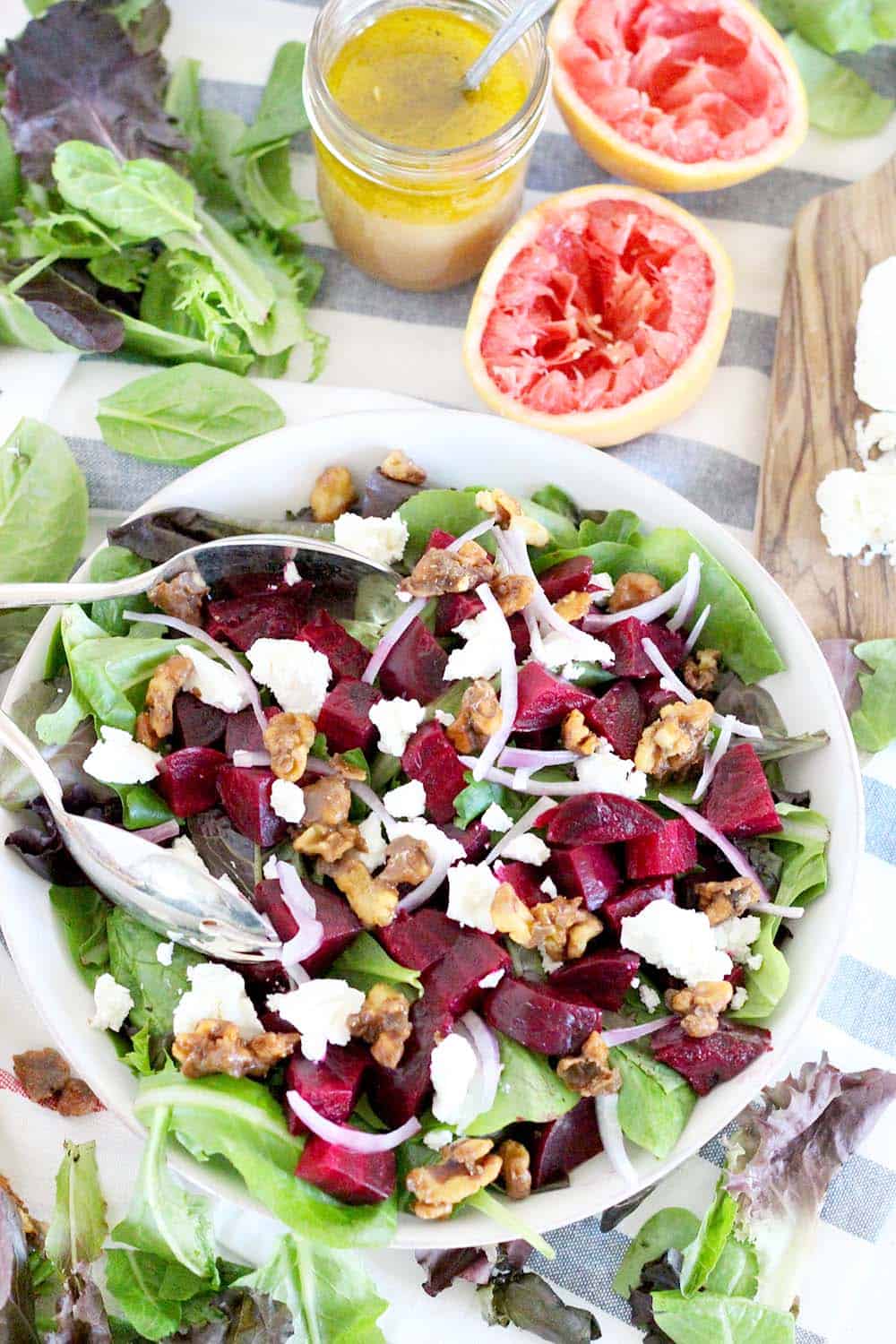 This healthy Roasted Beet Salad with Grapefruit Vinaigrette is the perfect thing to enjoy year round or as a colorful side for the holidays. Packed with goat cheese and candied walnuts, the ingredients combine to make the most perfect salad combination EVER! | www.bowlofdelicious.com