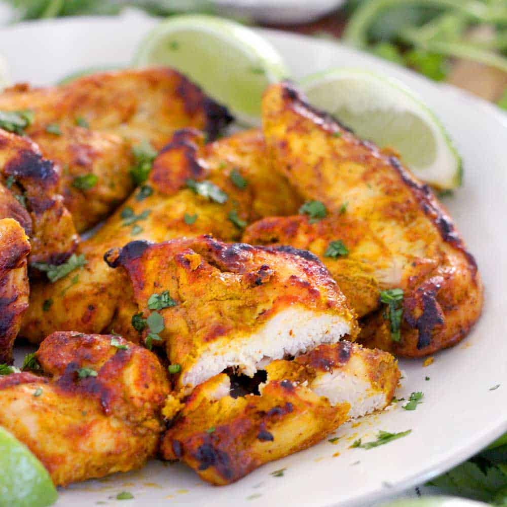 This Oven Broiled Tandoori Chicken is super flavorful, charred, and smoky- just like at your favorite Indian restaurant! This healthy, low carb recipe takes only 20 minutes to cook and is perfect on its own or in your favorite Indian chicken dish.