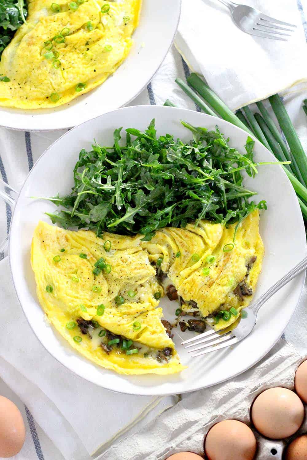 These Mushroom and Cheddar Omelettes are the perfect low-carb, healthy, fast meal to make any time of the day! This vegetarian recipe takes only ten minutes to throw together.