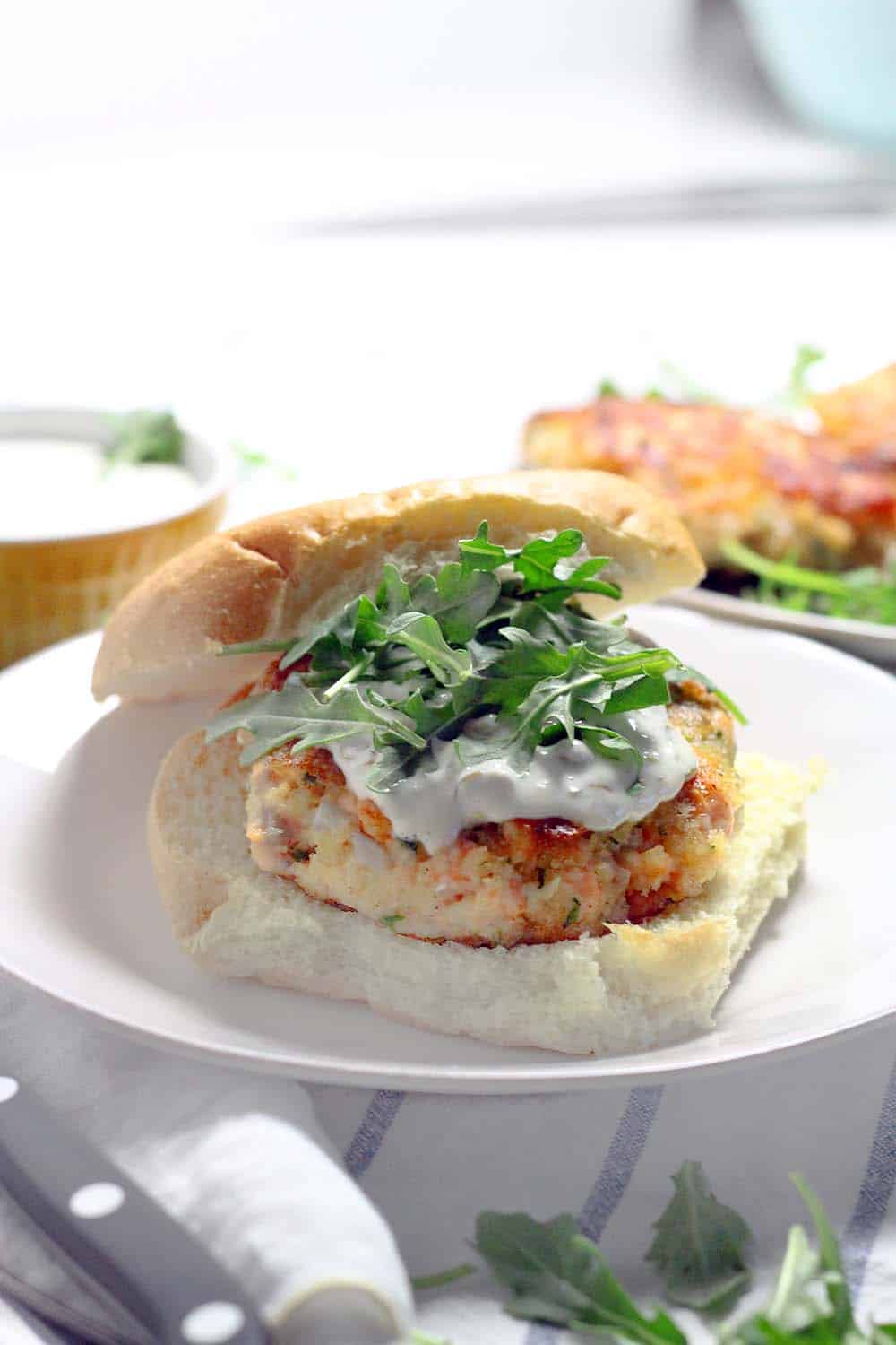 These Salmon Burgers are topped with a Lemon Caper Aioli and are SO easy to make! This recipe is perfect for a healthy alternative to traditional burgers and great for the Lenten season.