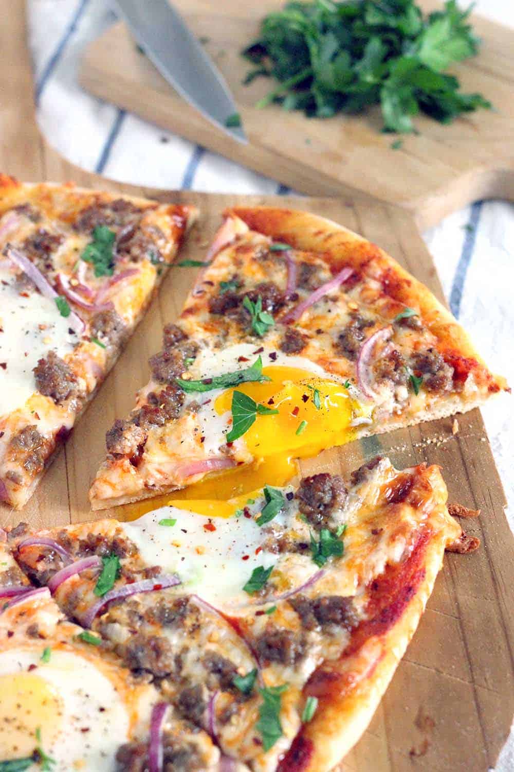 Pizza for breakfast?! Just put eggs on it! This Sausage Breakfast Pizza recipe is perfect for brunch and takes only 20 minutes to make. Use a cast iron pizza pan for best results.