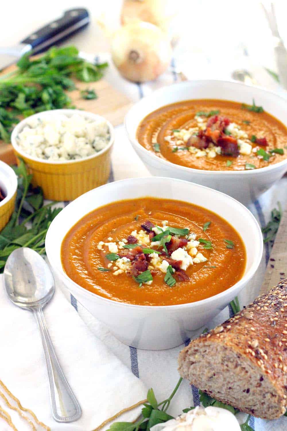 This Smoky Sweet Potato Soup is topped with crunchy bacon and tangy bleu cheese crumbles- an easy and DELICIOUS recipe for cold winter and early spring evenings! Vegetarian/vegan/Paleo optional. 