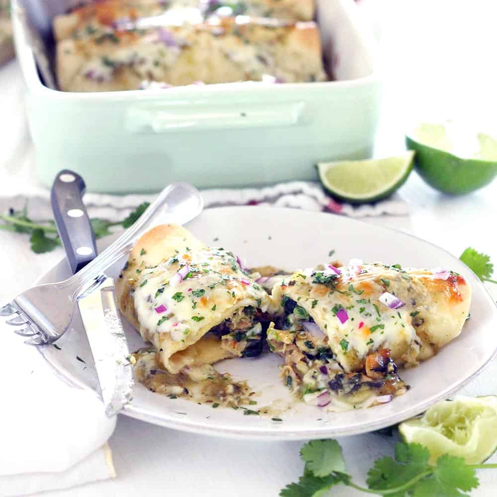 These Chicken and Spinach Enchiladas Verdes are my FAVORITE enchiladas! The recipe is freezable and packed with healthy greens, the chicken is marinated in a delicious jalapeño garlic mixture, and they're topped with jarred roasted tomatillo salsa for a quick and easy shortcut.