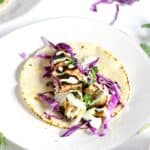 These Chipotle Salmon Tacos with Cilantro Lime Crema come together in only 15 minutes! The spicy chipotle flavor is balanced by the cool crema. This is my FAVORITE fish taco recipe.