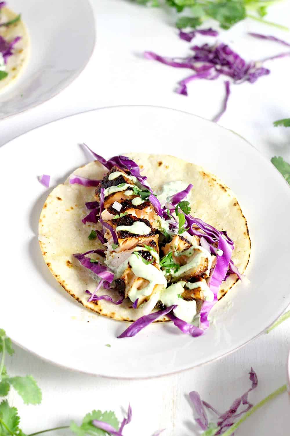 These Chipotle Salmon Tacos with Cilantro Lime Crema come together in only 15 minutes! The spicy chipotle flavor is balanced by the cool crema. This is my FAVORITE fish taco recipe.