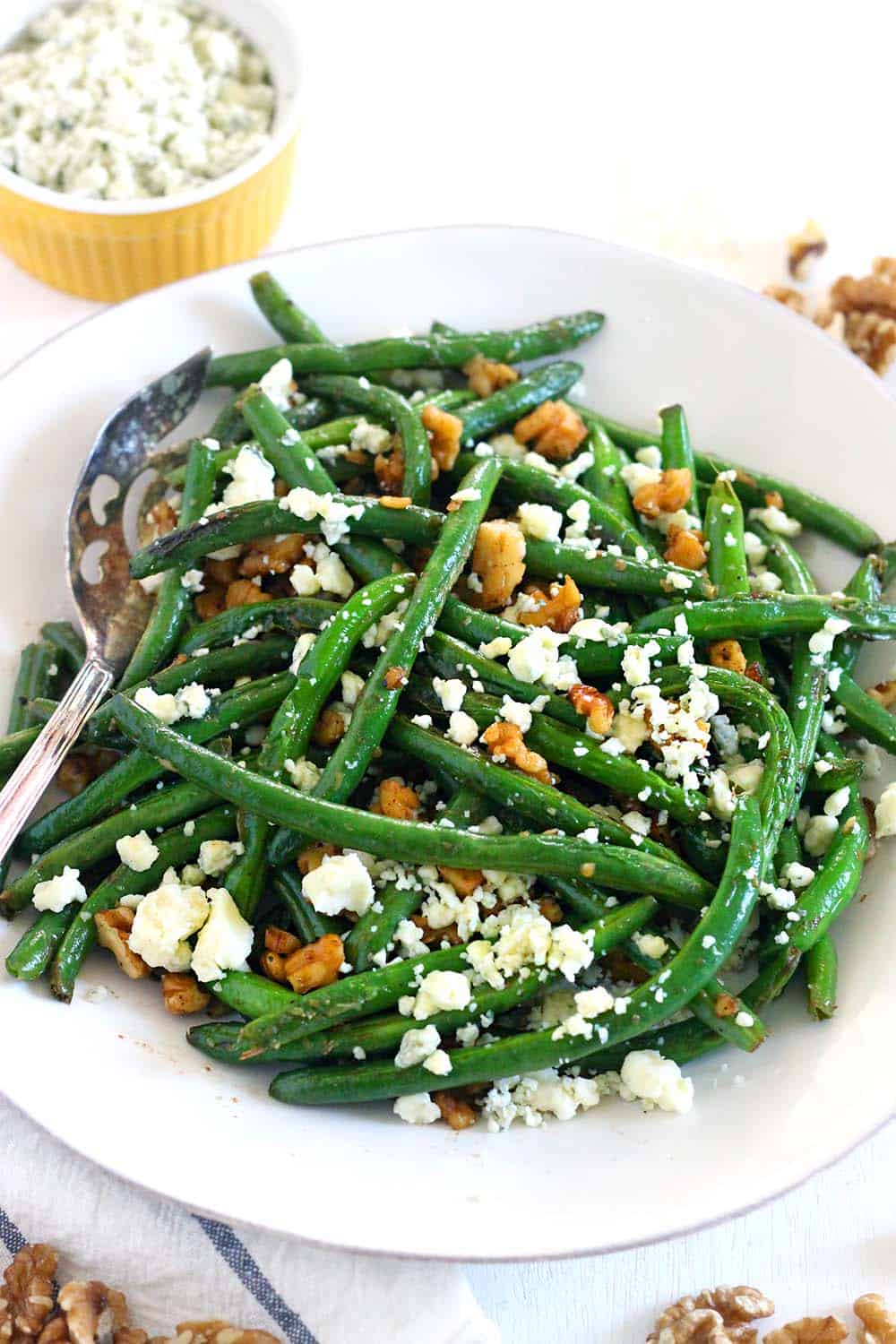 Green Beans Sautéed until crisp-tender, garnished with bleu cheese crumbles and chopped walnuts. This is a delicious way to eat more healthy greens, it takes 10 minutes, and it's healthy, gluten-free, and easy to make. Goes perfectly with anything buffalo flavored!