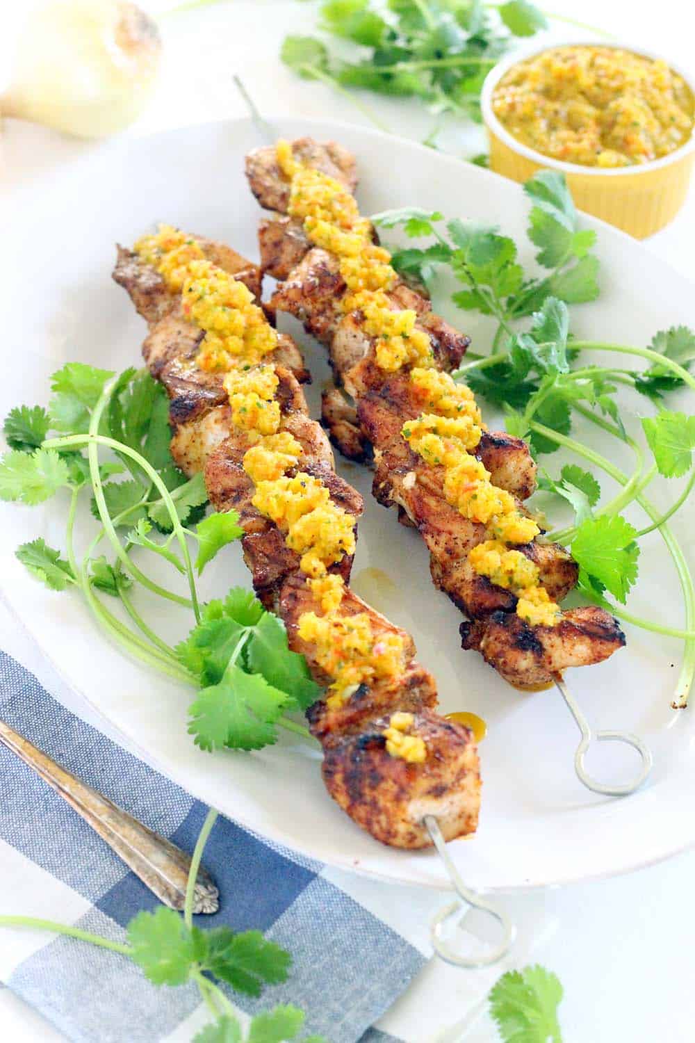 These Grilled Chicken Skewers and are DELICIOUS paired with charred Sweet Pepper Relish! Paleo, low-carb, and gluten-free. Everything cooks on the grill- use any extra relish for hot dogs at your next summer cookout.
