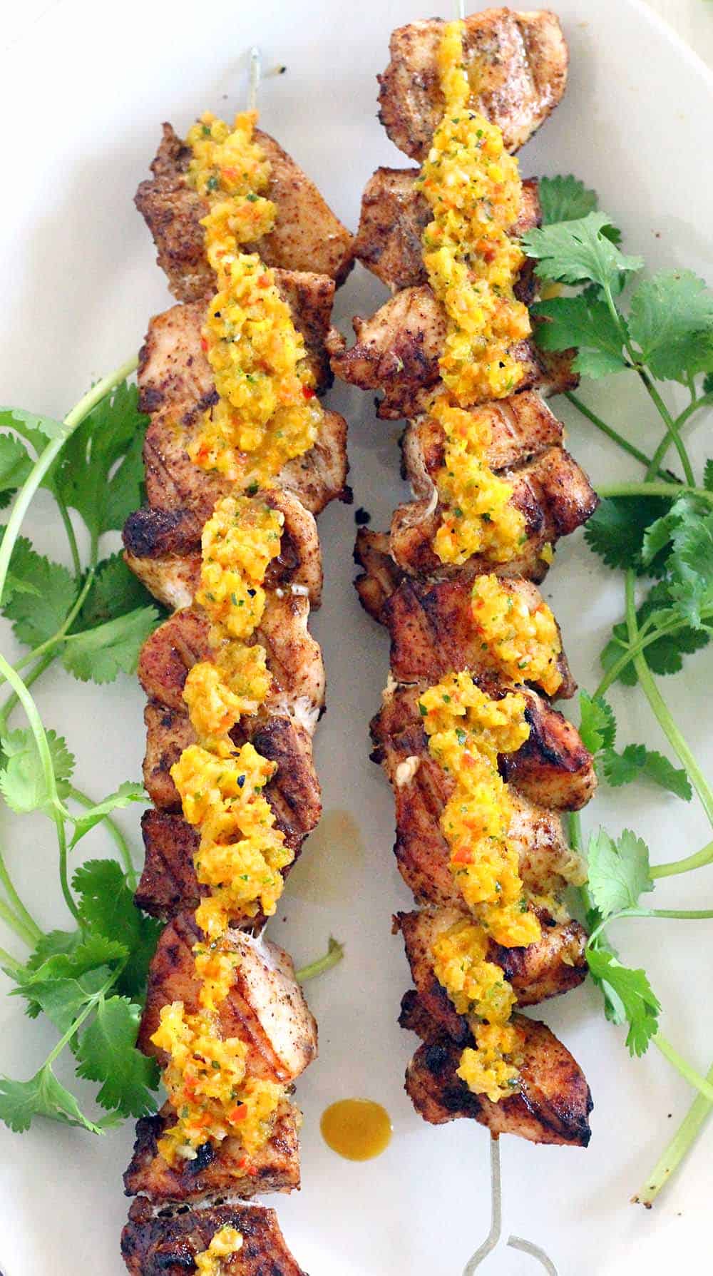 These Grilled Chicken Skewers and are DELICIOUS paired with charred Sweet Pepper Relish! Paleo, low-carb, and gluten-free. Everything cooks on the grill- use any extra relish for hot dogs at your next summer cookout.