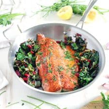 One Pan Garlic Butter Salmon and Swiss Chard- This healthy, gluten-free, low-carb recipe comes together in only 20 minutes! Can easily be made paleo or whole30 compliant by using ghee instead of butter.