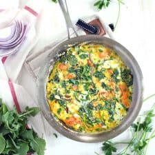 This salmon, arugula, and feta frittata is a great way to use up leftover cooked salmon! This low-carb, gluten free, easy recipe comes together in only 20 minutes.