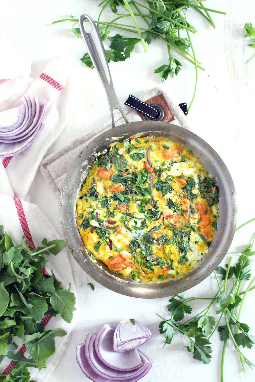 This salmon, arugula, and feta frittata is a great way to use up leftover cooked salmon! This low-carb, gluten free, easy recipe comes together in only 20 minutes.