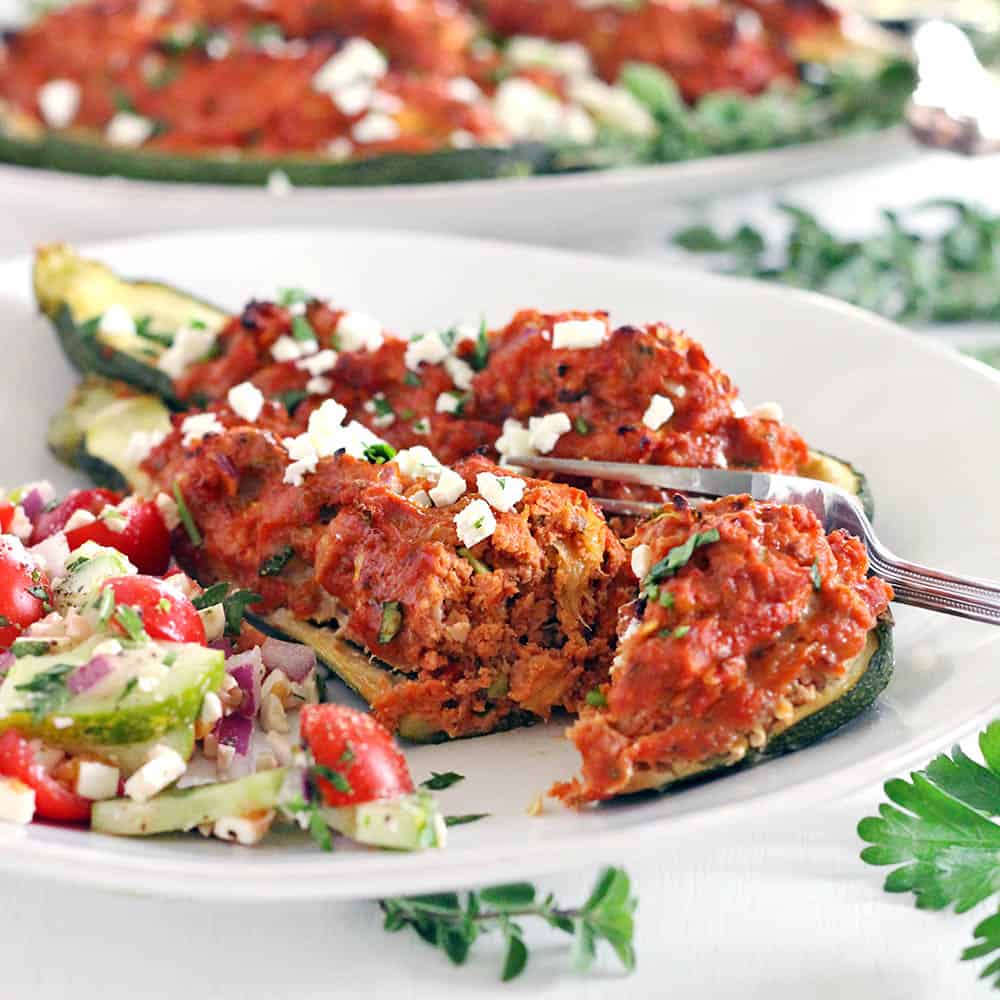 These Paleo Greek Stuffed Zucchini Boats are super healthy and low-carb! Made with lean ground turkey and seasoned with Mediterranean flavors. Only 15 minutes of prep!