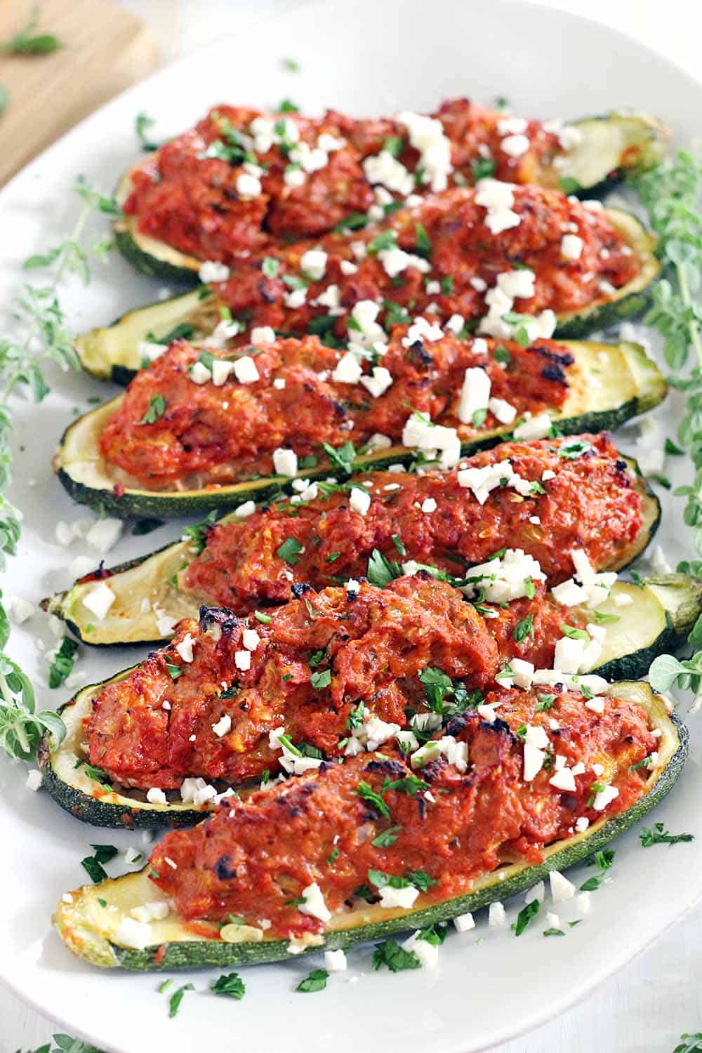 These Paleo Greek Stuffed Zucchini Boats are super healthy and low-carb! Made with lean ground turkey and seasoned with Mediterranean flavors. Only 15 minutes of prep!