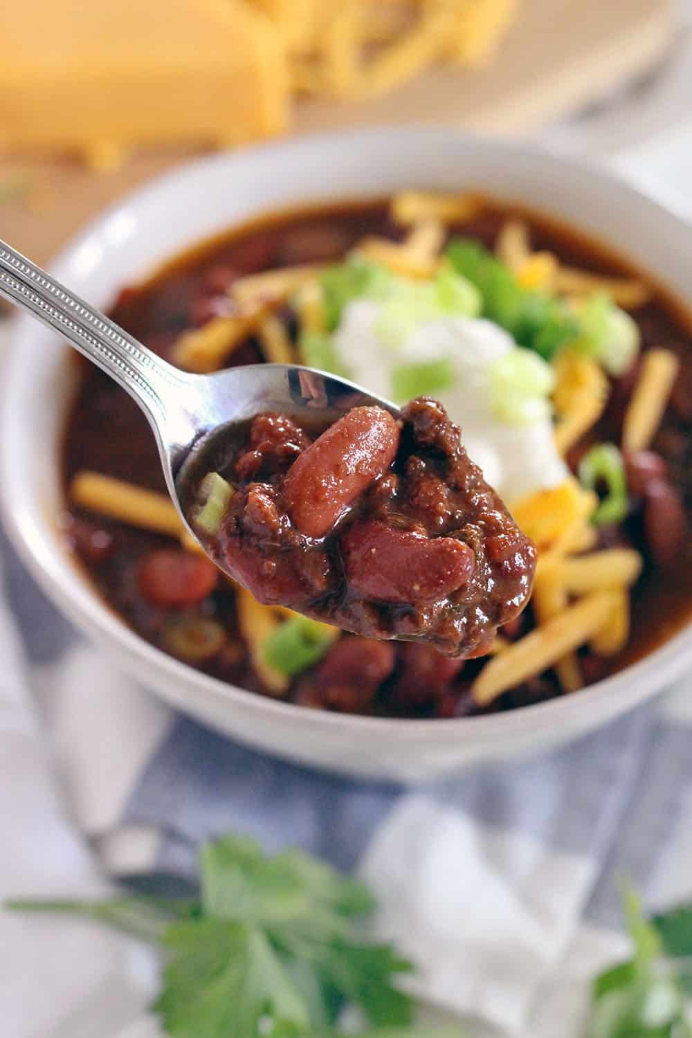 This Instant Pot Chili is made with ground beef and dry kidney beans, and comes together in less than an hour! It's cheap, healthy, and DELICIOUS.