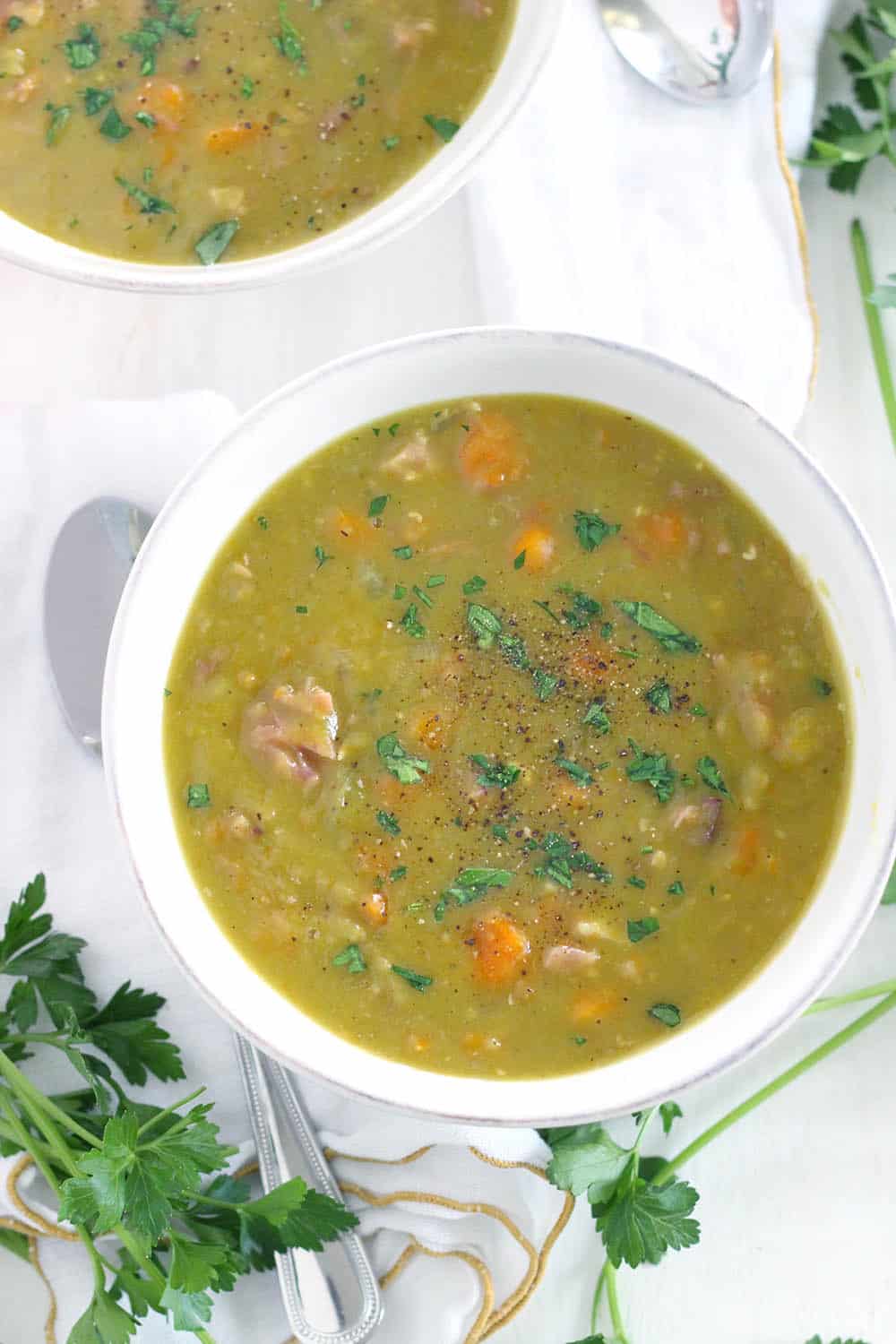 This Instant Pot Split Pea Soup is made with a leftover ham bone (or any ham you have), for a super easy, freezable weeknight meal! The pressure cooker cuts the cooking time in half. #InstantPot #splitpeasoup #PressureCooker